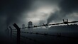 © Nataly - Dark and foggy concentration camp scene with barbed wire fence. Watchtowers and barracks under a somber sky with smoke. Holocaust remembrance concept