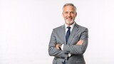Confident mature businessman smiling with arms crossed. Successful senior professional executive in a gray suit isolated on a white background with copy space
