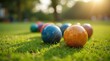 © Alex Pios - Close-up of colorfully designed lawn bowls on a green outdoor bowling green in bright sunlight