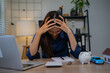 © Laingzaifa - Business professionals are stressed out reviewing accounting records, dealing with debt, bankruptcy, losses from the economic recession, worrying about loans, income, assets, taxes, and frantically