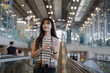 © Jirapaporn - Asian female photographer traveling with camera at modern airport