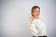 © Nenad - Businesswoman over isolated background pointing up a great idea