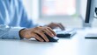 © photostockatinat - Precision and productivity: A person's hand skillfully maneuvers a mouse while the other hand types on a keyboard. Capturing focus and the tools of modern digital work.
