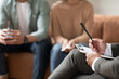 © Prostock-studio - Unrecognizable couple having therapy session at psychotherapists office, selective focus on male professional psychologist holding pen and clipboard, writing in notepad, talking and consulting clients