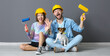 © Pixel-Shot - Young couple with painter's tools and cute dog near grey wall