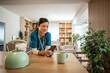 © Migma_Agency - Nurse taking break checking mobile phone in kitchen