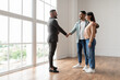 © Prostock-studio - Sealing A Deal. Millennial Couple Buying New Apartment, Husband Hugging Wife And Shaking Hands With Professional Real Estate Agent. Smiling Manager In Suit Selling Flat To Happy Young Family