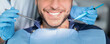 © Prostock-studio - Unrecognizable male patient having teeth whitening procedure at modern dental clinic, smiling at camera, dentist hands in rubber gloves with dental tools. Banner for dental clinic, panorama