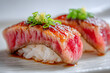 © Thisisbest - Close-up View of Two Elegant Pieces of Kobe Beef Sushi Artfully Garnished with Green Onions