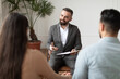 © Prostock-studio - Family Psychologist Concept. Portrait Of Marriage Male Consultant Wearing Suit Talking With Couple Sitting In Office, Holding Clipboard With Pen, Having Session Giving Professional Advice