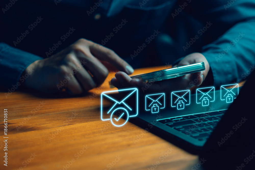 Secure email and cybersecurity concept. Person using smartphone and laptop with glowing blue hologram icons of encrypted messages, verified mail, and digital data protection.