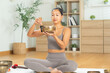 © Leny Studio - Tibetan singing bowl sound healing, Asian woman meditating at home yoga session, bronze instrument and mallet on cushion, calm breath practice, mindfulness wellness, zen harmony, serene peaceful