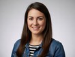 © Vooglo.com - Young woman with long brown hair wearing a blue denim jacket
