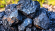 © Liu - Raw molybdenum ore crystals on black shale with metallic reflections,showcasing strategic mineral resources and clean energy materials for industrial use.