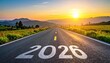 © Es - Road with '2026' towards a sunrise over mountains