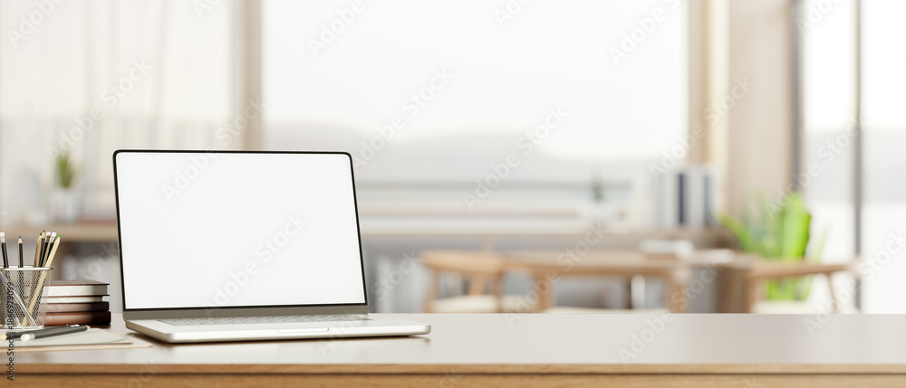 White screen laptop with books and pencils on wooden counter table ...