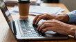 © zhang - Close-Up of Hands Typing on Laptop Keyboard in Office Workspace