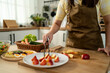 © Kawee - Close up of woman cooking healthy foods in kitchen in morning at home.