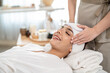 © Kawee - Beautiful woman getting head and facial massage treatment at beauty spa