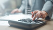 © Garun Studios - tax, invoice, receipt, document, A business person using a calculator with digital tax invoice documents, representing billing, tax calculation, accounting tasks, and financial record management.