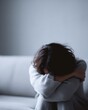 © KASUEMA SALAE - Mental health loneliness concept, stressed woman sitting alone on sofa feeling depressed