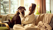 © master1305 - Dog sitting calmly on sofa at home while owner gently holds its head. Concept of pet care advertising, dog health check, everyday pet care routine and responsible home pet maintenance.