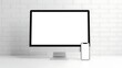 © graphic35 - Computer monitor and smartphone on white desk against brick wall