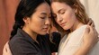 © Fernando - Two women, one Asian and one White, embracing with eyes closed in a moment of comfort and connection, outdoors during daylight Concept of friendship, support, and intimacy