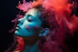 © juliars - Woman's profile enveloped in vibrant, ethereal powder smoke on a dark background