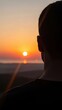 © soojin - Back view of a man watching the sunrise