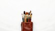 © MakeitEasy - A collection of painting supplies neatly arranged in a briefcase style leather case, emphasizing organization and portability for an artist's tools.
