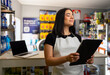 © freechoice - Woman standing in her retail store, feeling proud and successful, breathing with eyes closed