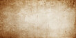 © RASEL - Aged vintage brown parchment with a stained grunge texture provides a blank antique paper background featuring a worn and damaged retro design for a weathered ancient page wallpaper pattern