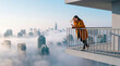 © Rendara Studio - Woman using a smartphone on a balcony overlooking a foggy city skyline