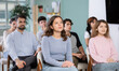 © JackF - Young people are listening to lecture in auditorium, students listen to teacher. Personal growth courses, group psychological interaction, practical classes in psychology