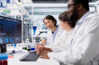 © DC Studio - Multiethnic lab researchers team evaluating genetic markers associated with disease risk on PC. Multiracial laboratory engineers study DNA strand mapping with genomics analysis program on computer