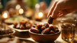 © Wahyu - Hand reaching for a date at a cozy dinner table setting, iftar in the ramadan