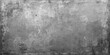 © Asad Shehbaz - A dark and dirty grunge metal wall background features a rough grey concrete texture with a vintage black cement pattern on an old weathered stone surface for a blank industrial design backdrop