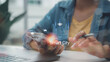 © FAMILY STOCK - Close up of hand holding smartphone with Smart City hologram interface, featuring IoT icons for urban planning, renewable energy and connected infrastructure in modern workspace.