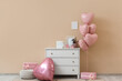 © Pixel-Shot - Interior of living room decorated for Valentine's Day with commode and pink balloons