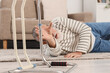 © Pixel-Shot - Senior man lying on carpet after fall with walker at home
