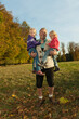 © Westend61 - Man holding two girls outdoors during autumn in Bavaria
