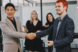 © ARMMY PICCA - Meeting, partnership and business people shaking hands in the office for a deal, collaboration or onboarding. Diversity, professional and employees with handshake for agreement, welcome or greeting.