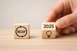 © Kultawatch - Strategic business recap analysis, hand moving the 2025 innovation lightbulb cube, perfect for economy reports and agreement planning