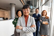 © Jelena - Professional Team in Office Setting Exhibiting Collaboration and Leadership
