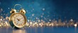© Sukses - A gleaming gold alarm clock on a blue gradient background with bokeh light particles