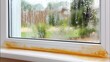 © pvl0707 - Mold and dirt build-up on window sill with blurred grass outside on a rainy day