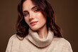 © Beauty Hero - Beautiful young woman in a beige sweater, styled against a soft gradient background, showcasing natural elegance