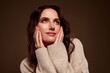 © Beauty Hero - Tender brunette woman in soft beige sweater posing with charm, expressing inner beauty, against gradient background