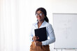 © Prostock-studio - Psychological education concept. Cheerful young black business coach conducting personal growth training at office. Confident female tutor giving professional development course, indoors